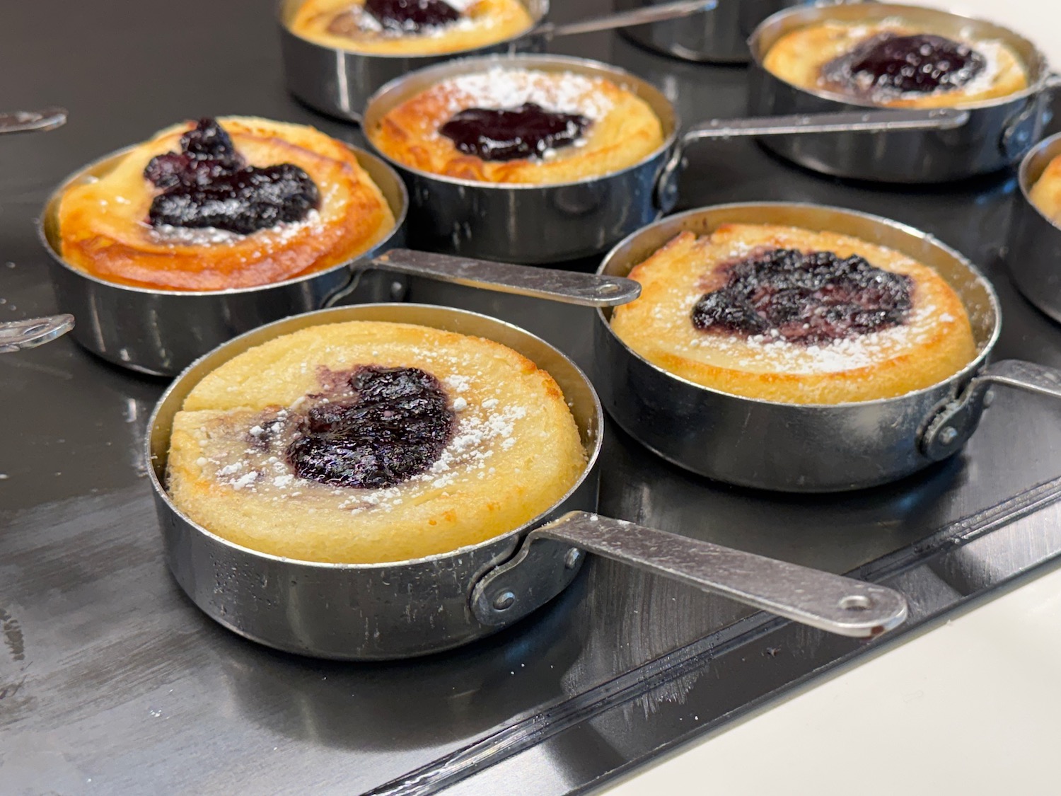a group of small pans with food in them