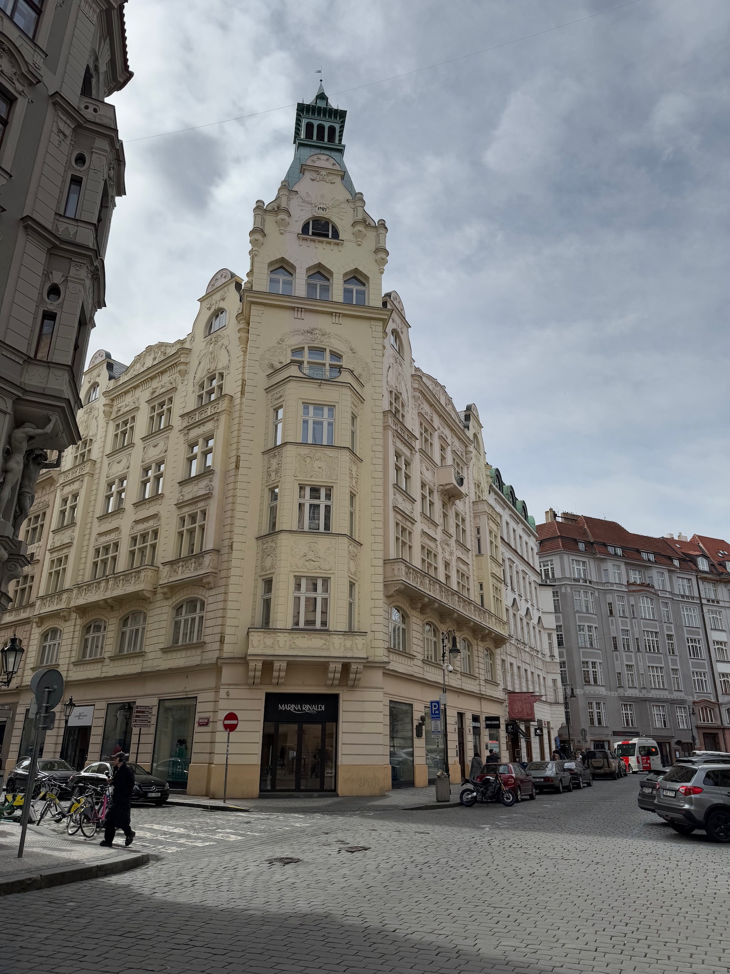 a building with a steeple on the corner of a street
