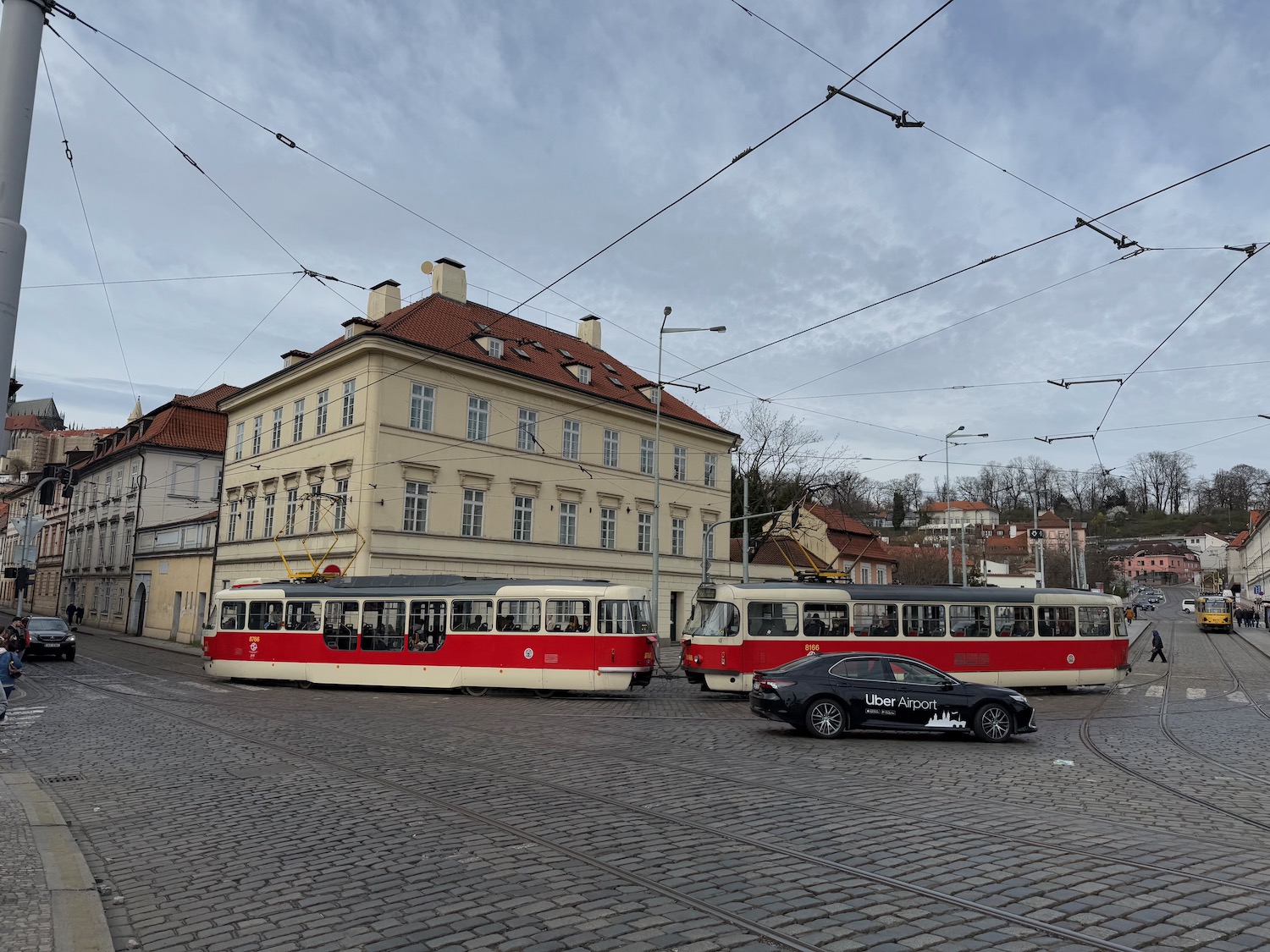 a street with a train and a car on it