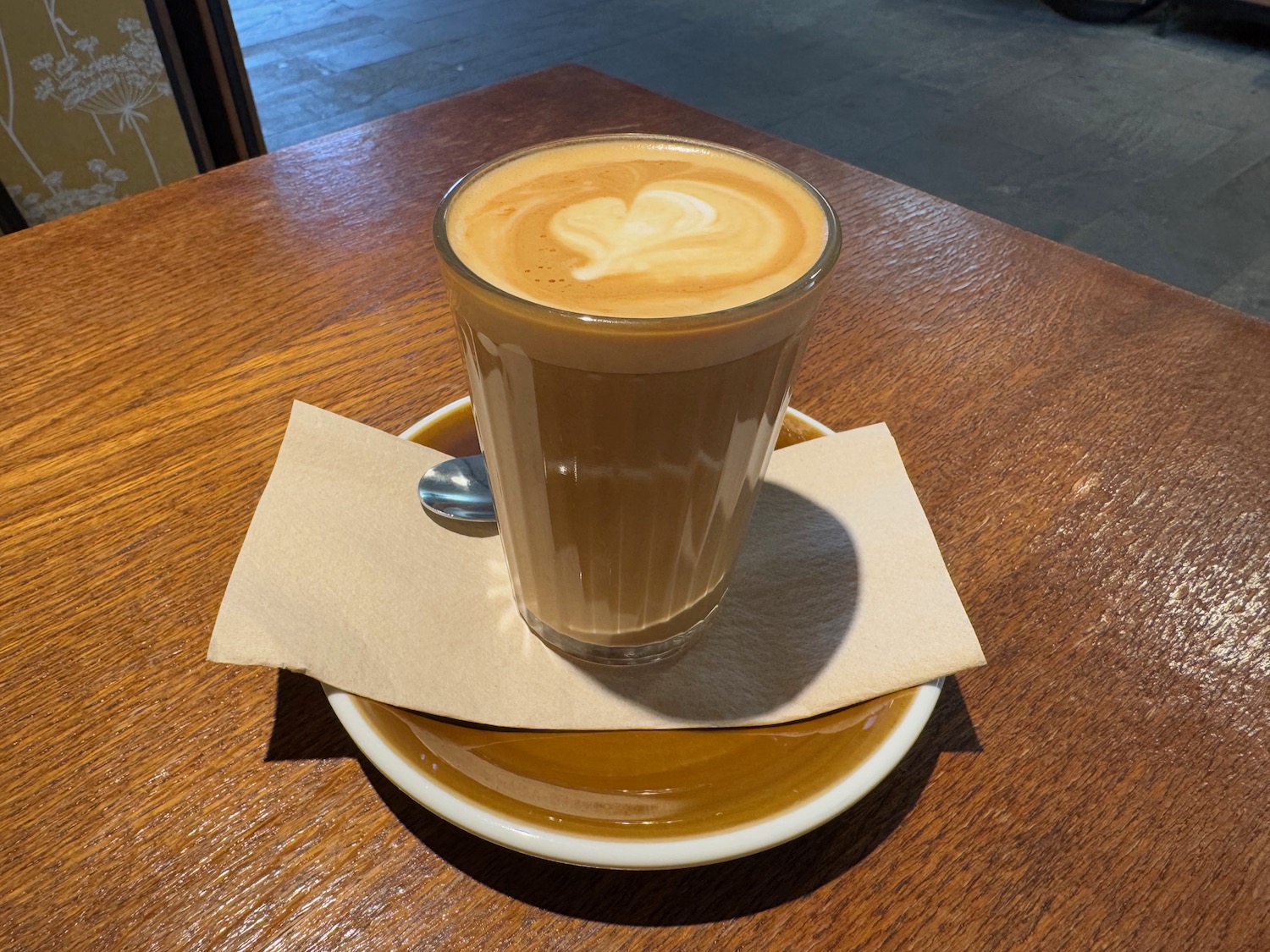 a glass of coffee on a plate