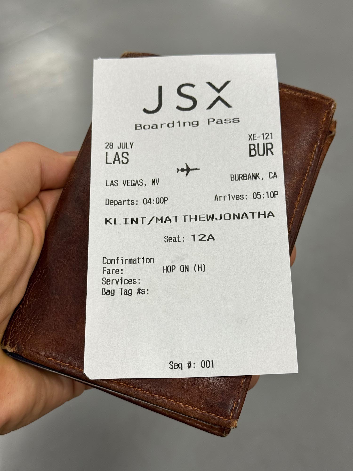 a hand holding a ticket