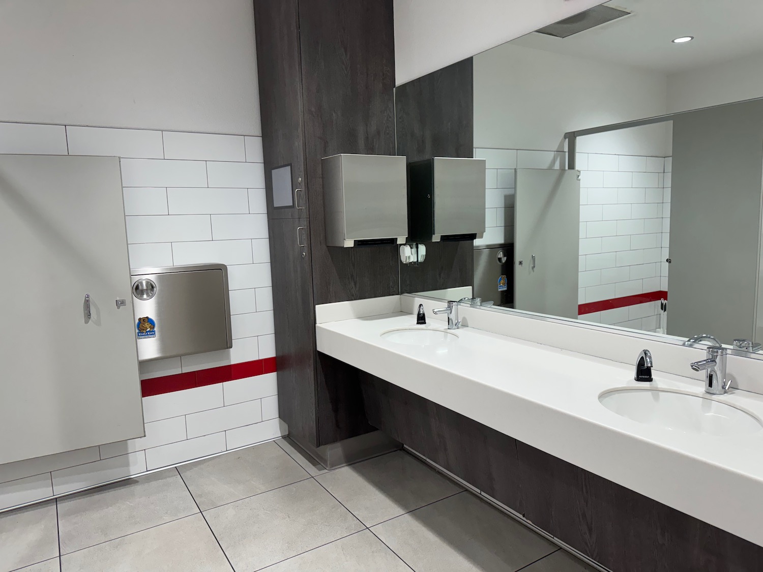 a bathroom with a large mirror and sinks