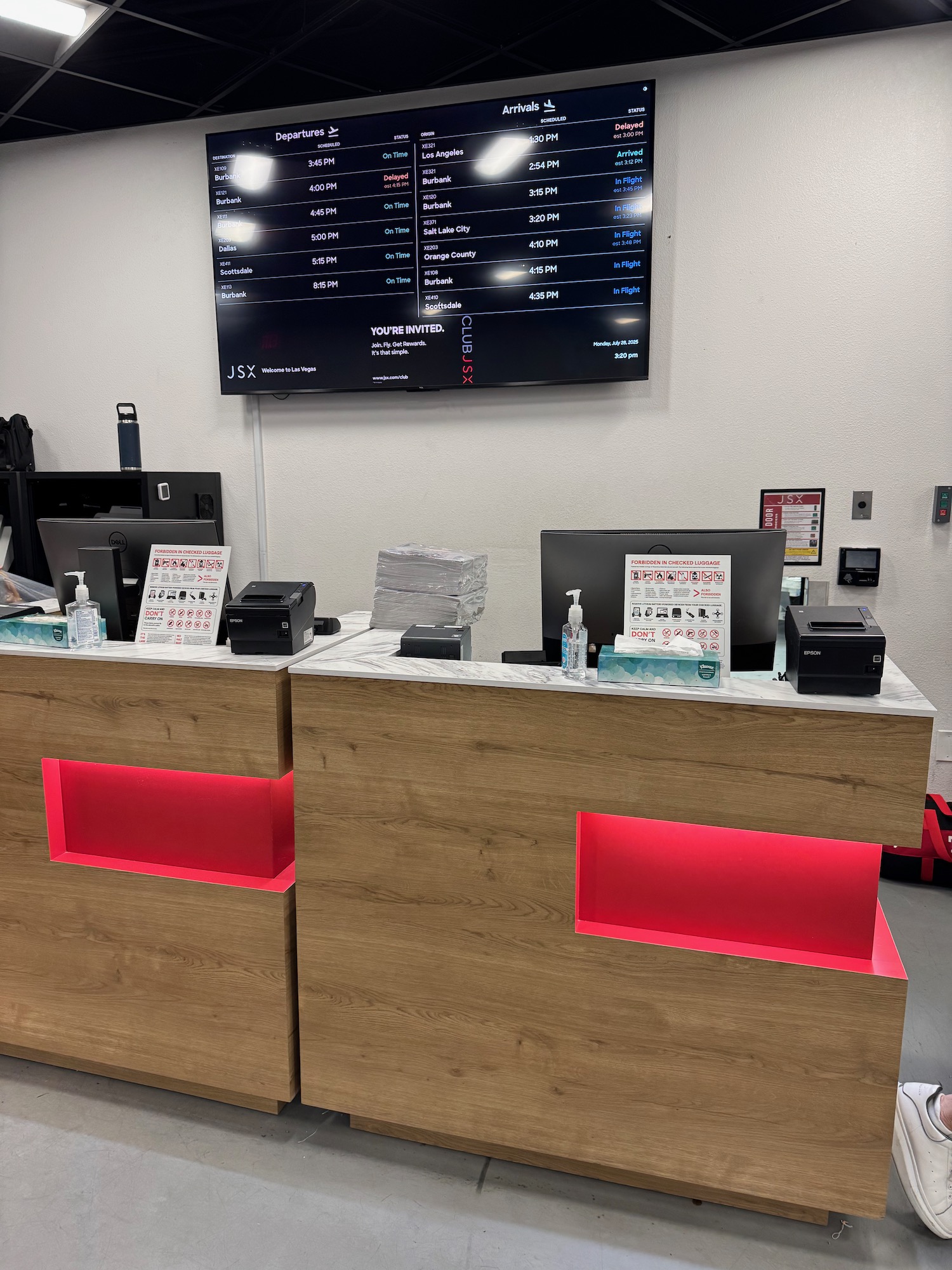 a desk with a screen on the wall
