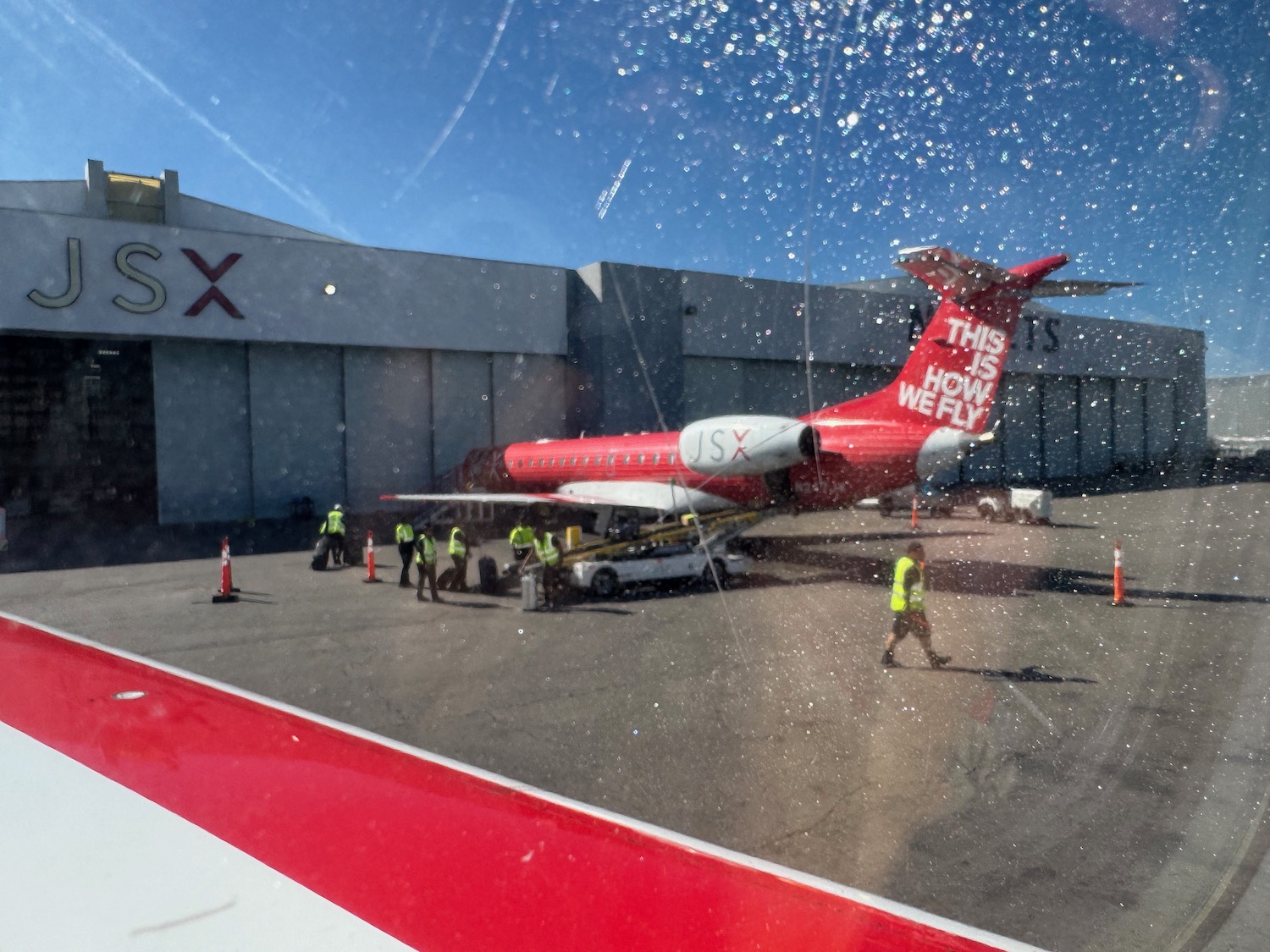 a red airplane with white text on it