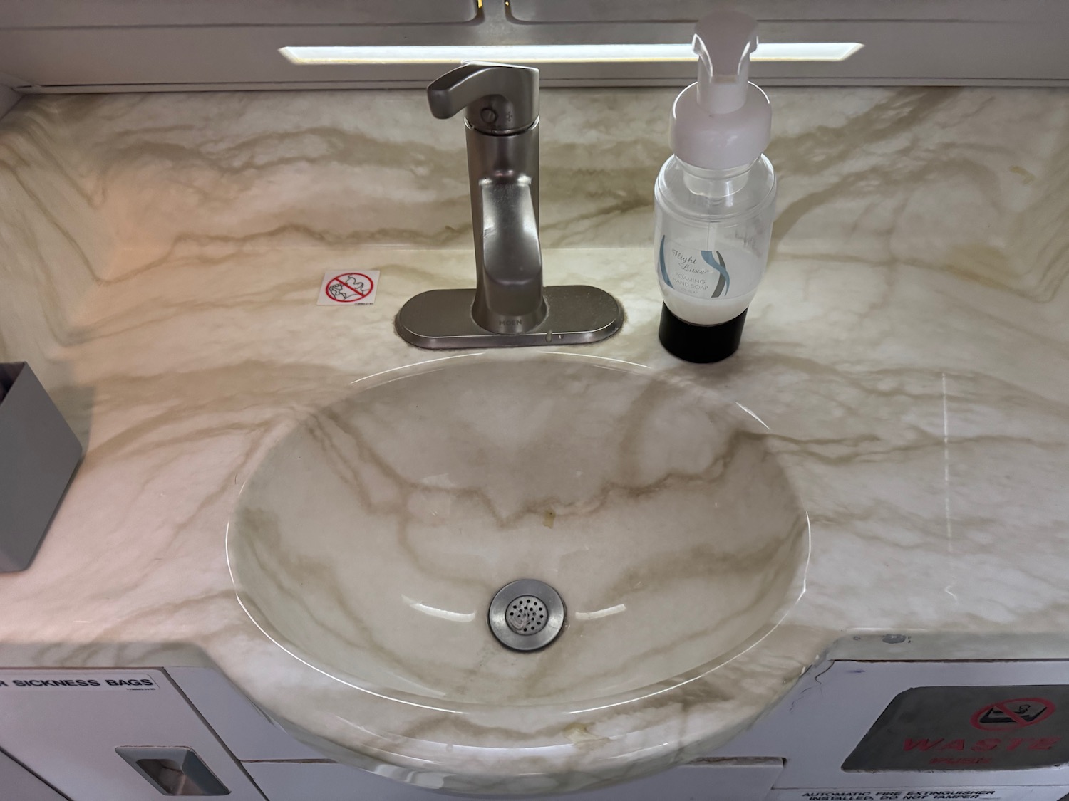 a sink and soap dispenser on a counter