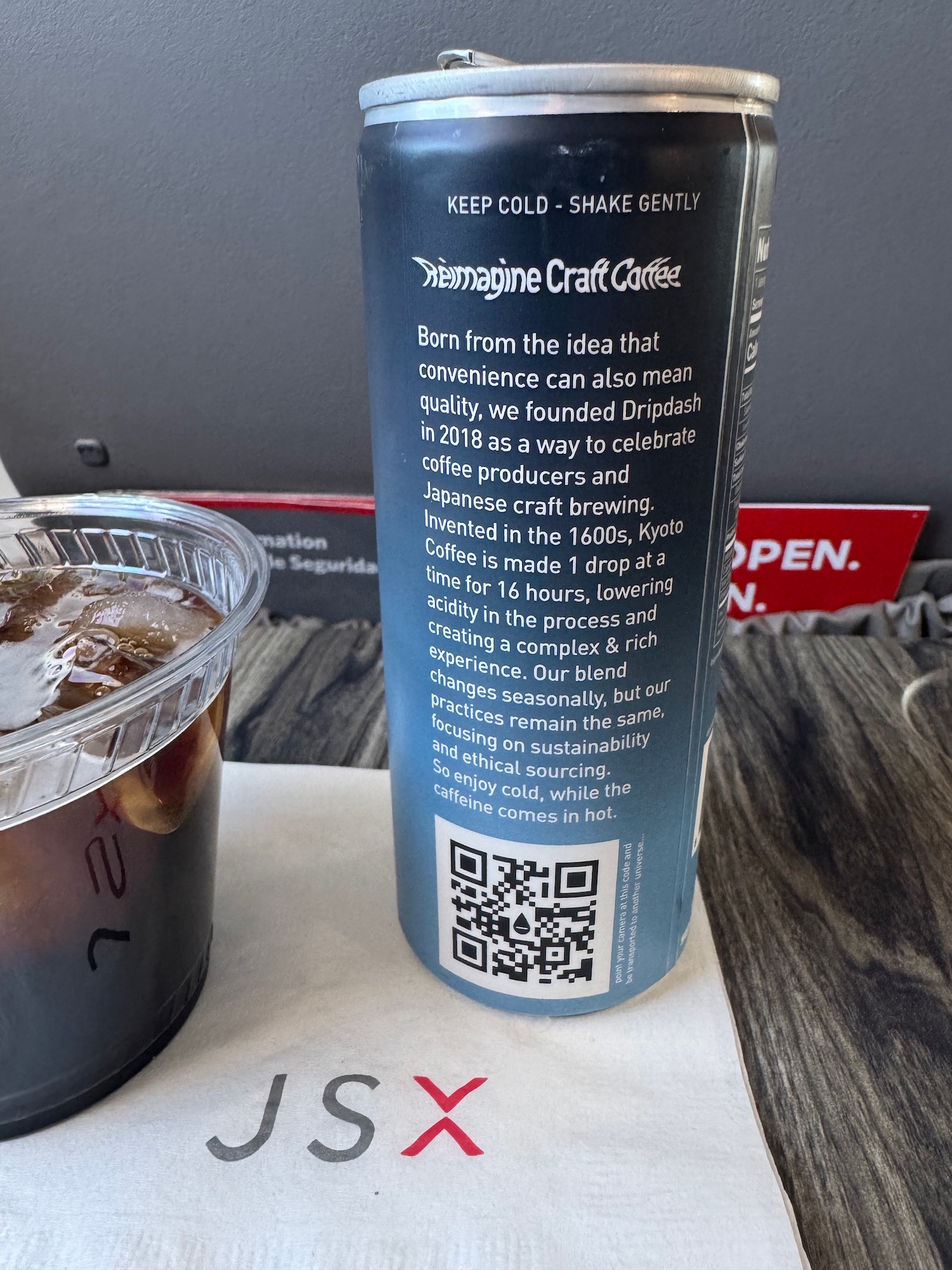 a can of liquid on a napkin
