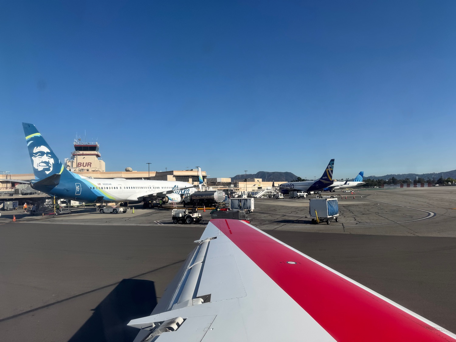 an airplane wing with a red stripe on it