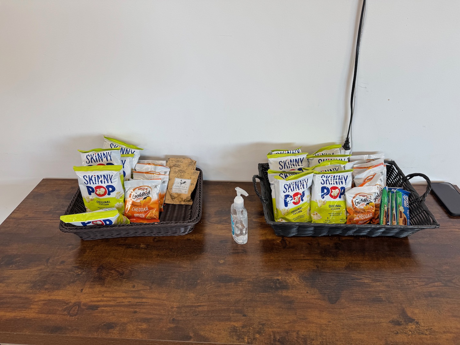 a basket of snacks and a hand sanitizer