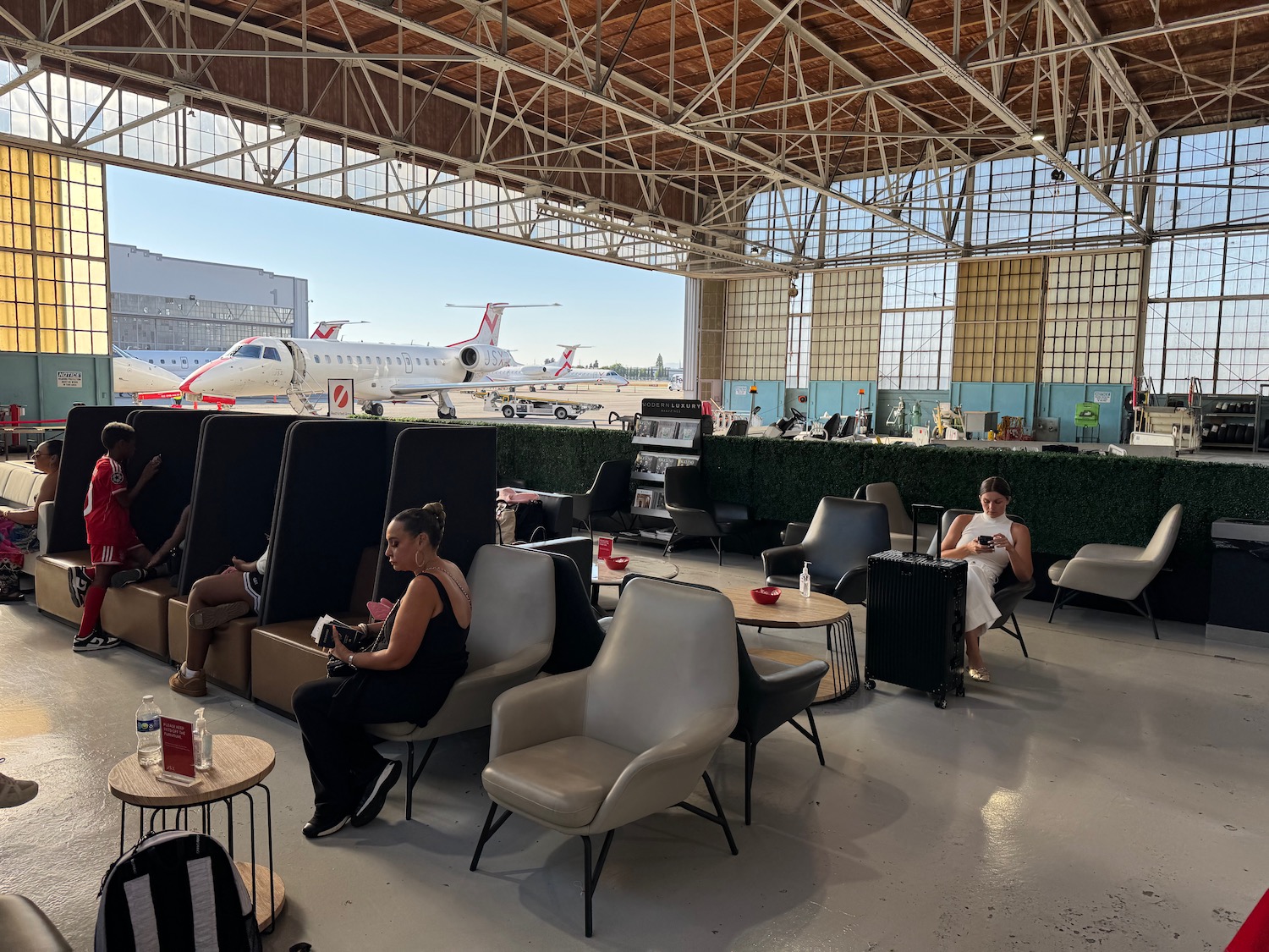 people sitting in chairs in an airport