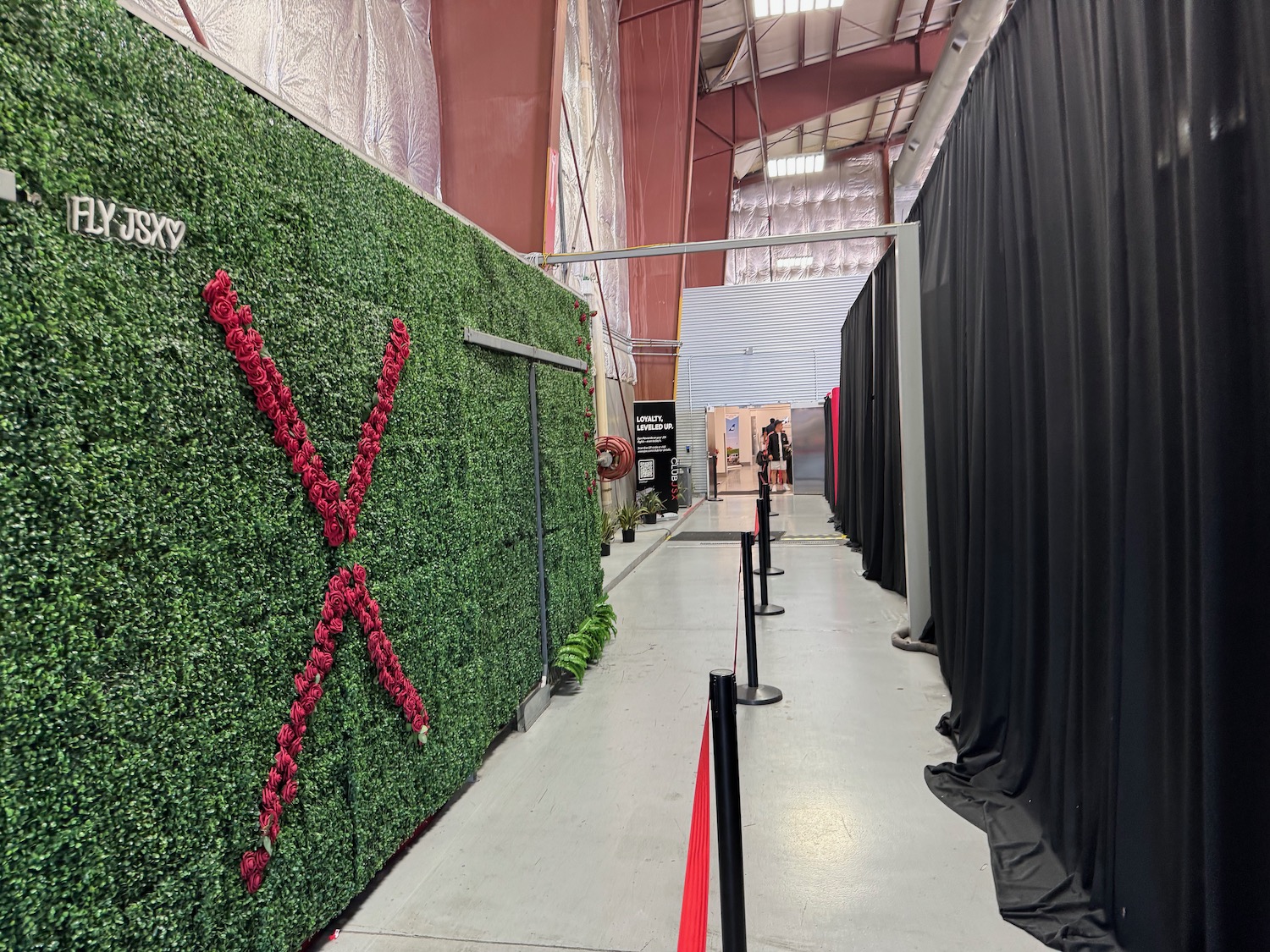 a green wall with red flowers