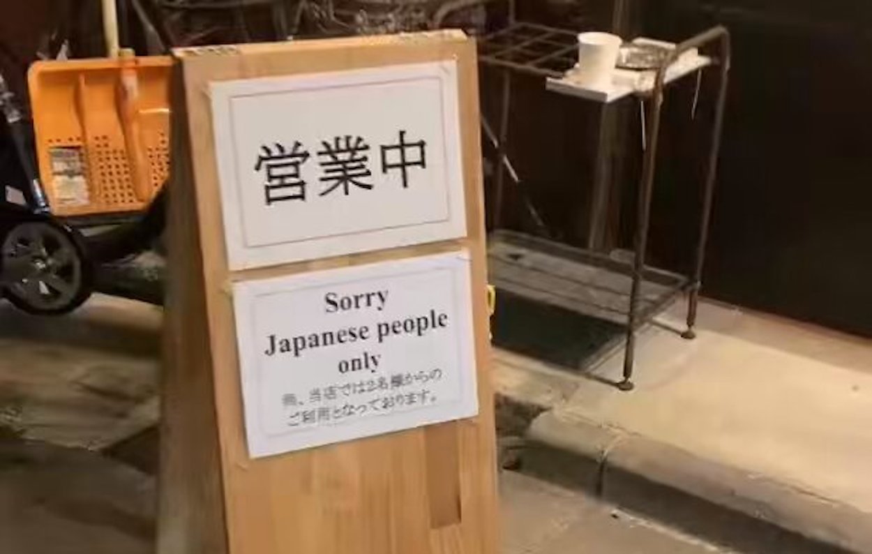 a sign on a wooden stand