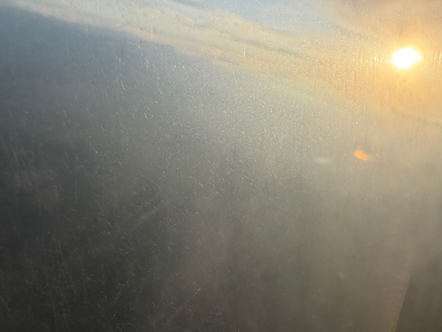 a sun shining through a window