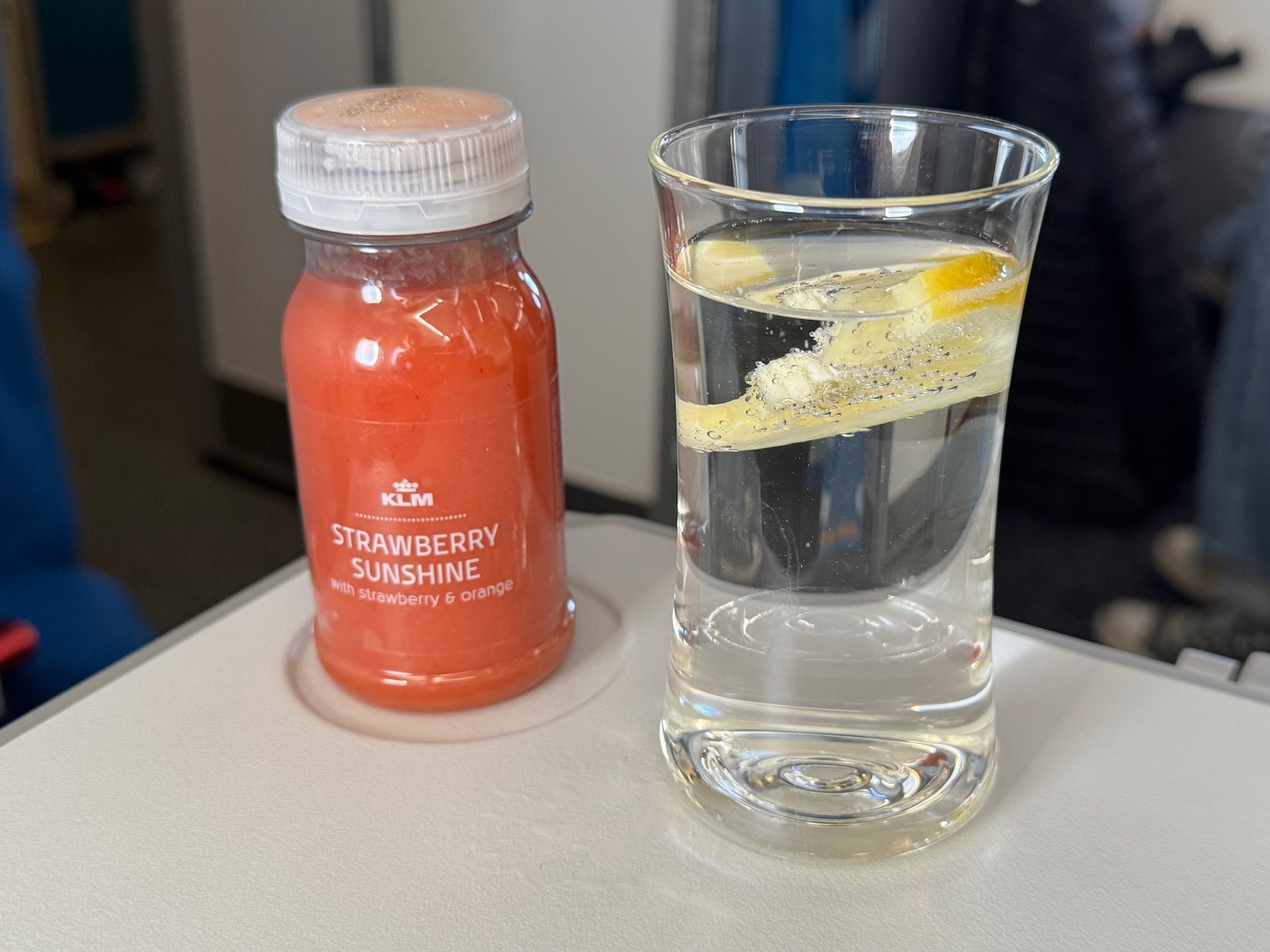 a glass of water and a bottle of juice