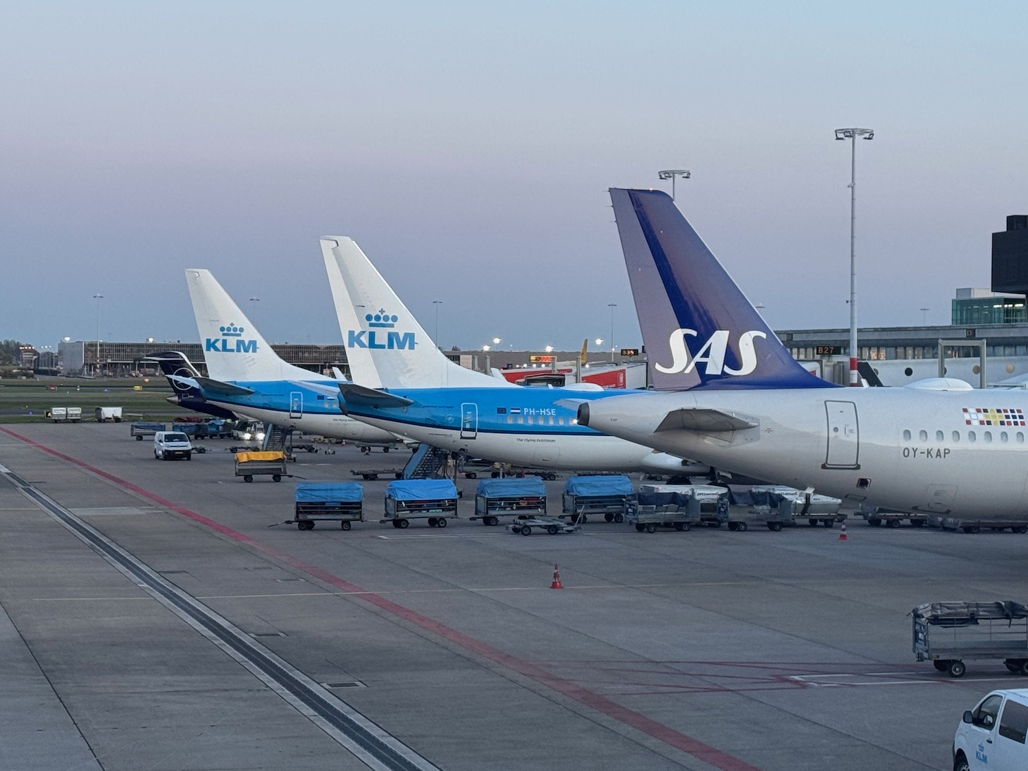 a group of airplanes parked at an airport