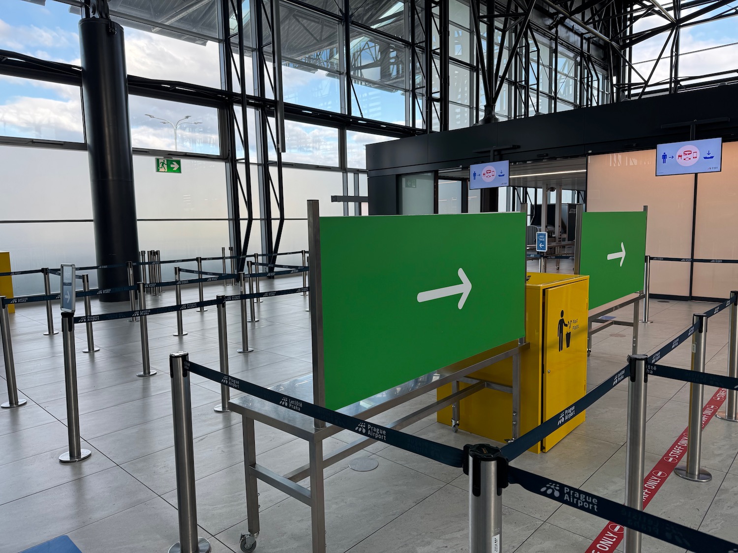 a green sign with arrow in a building