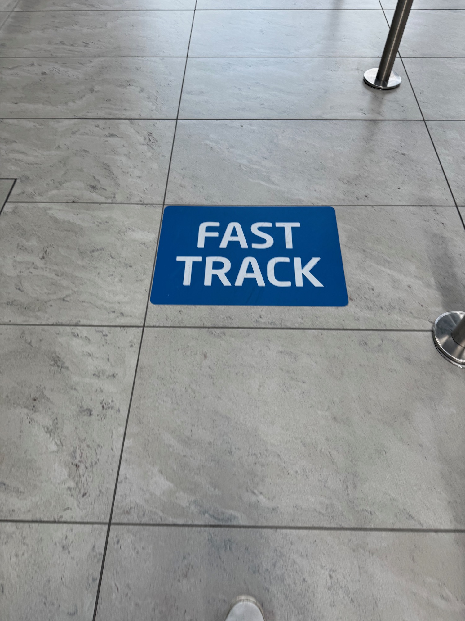 a blue sign on a tile floor