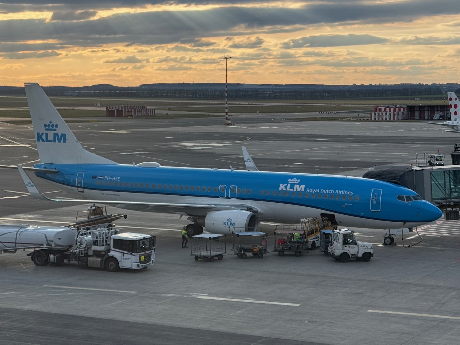 a blue and white airplane on a runway