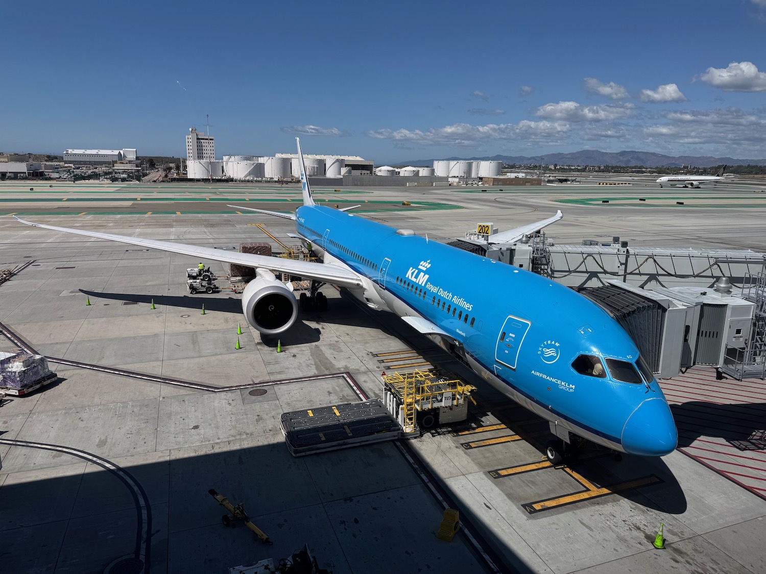 a blue airplane on a runway