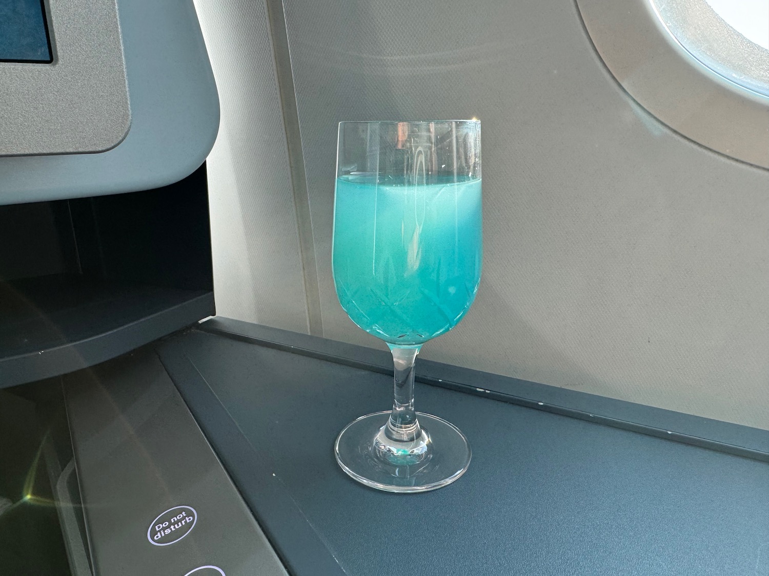 a glass of blue liquid on a table