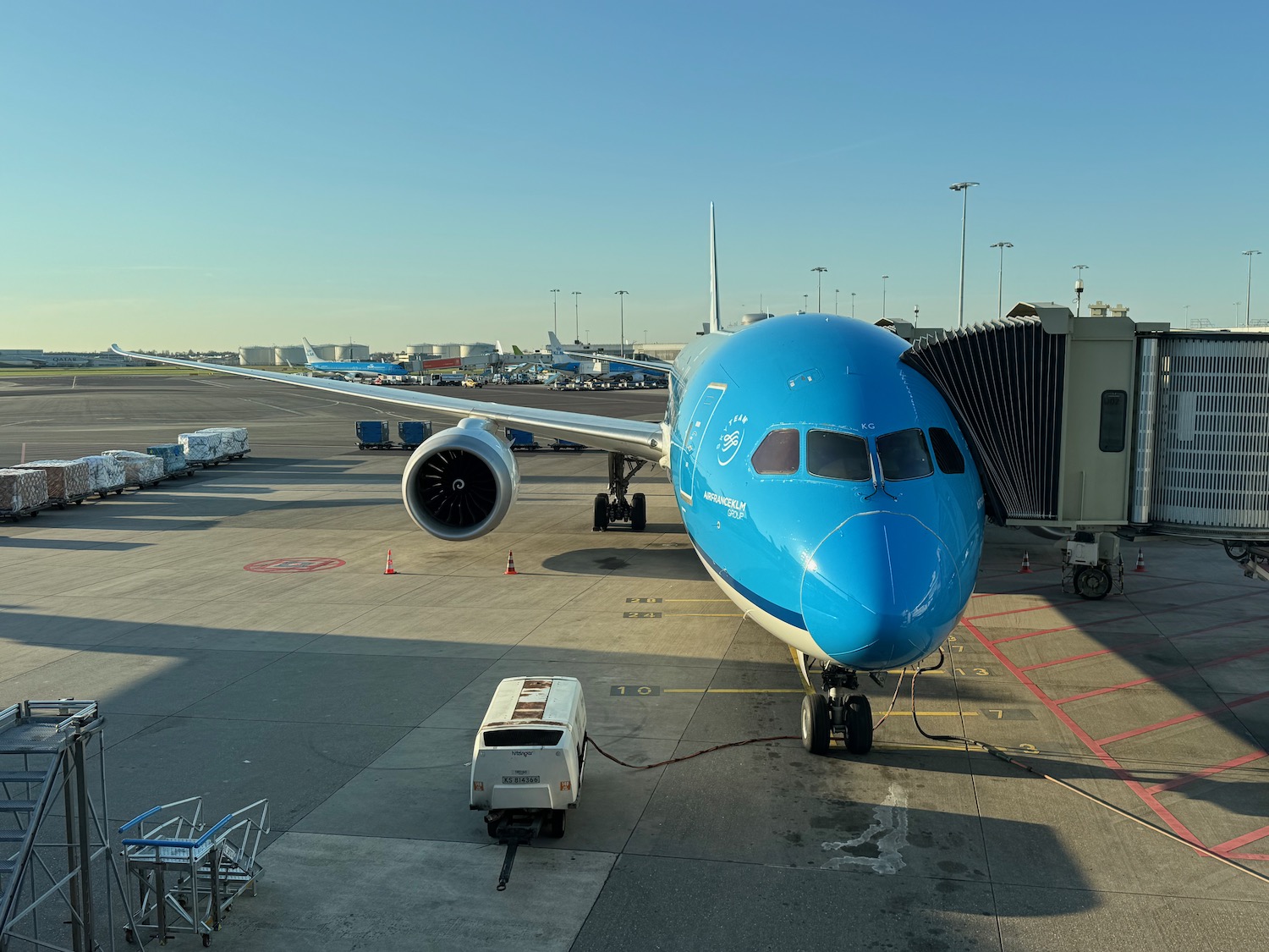 a blue airplane at an airport