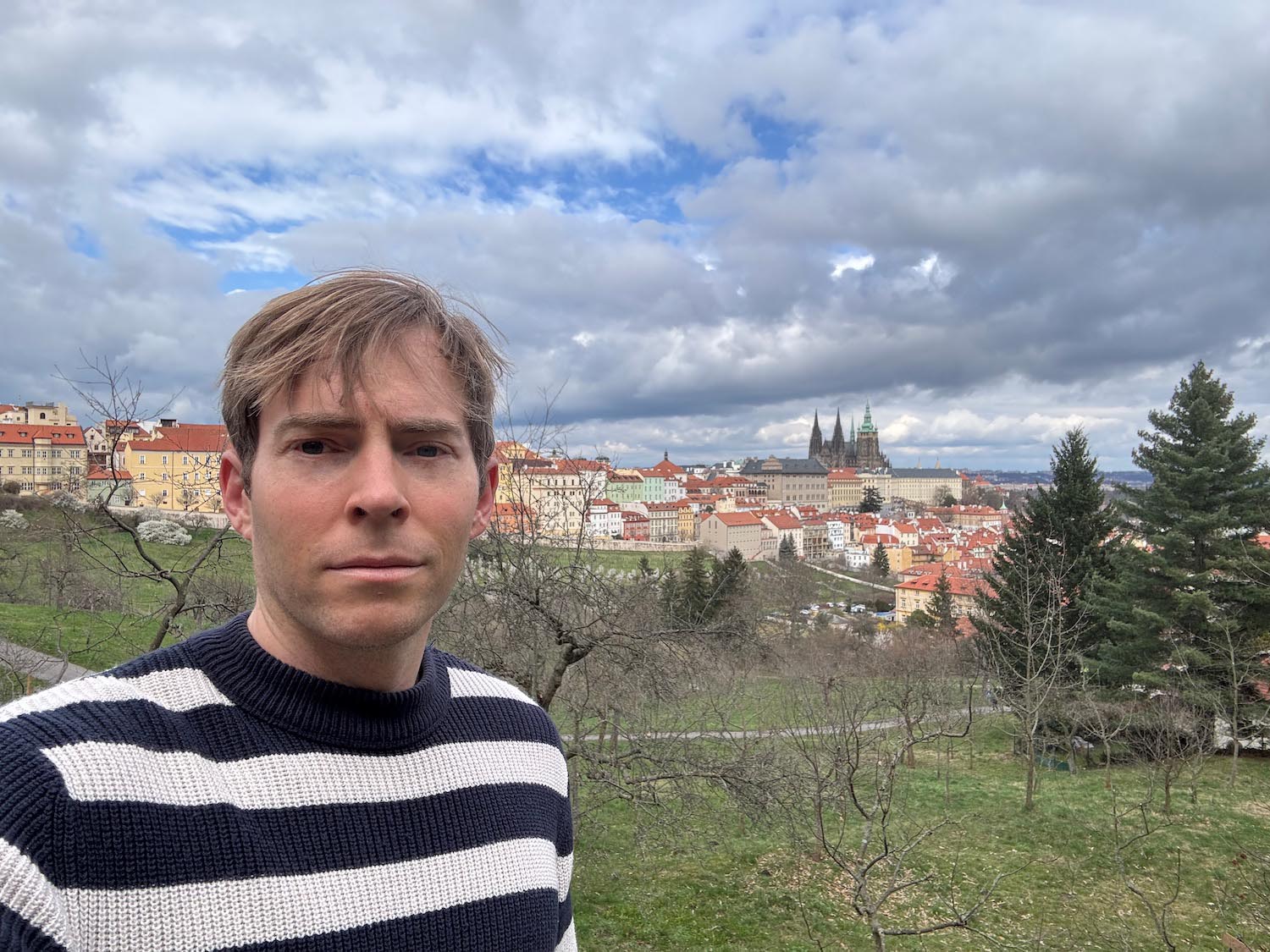 a man taking a selfie in front of a city