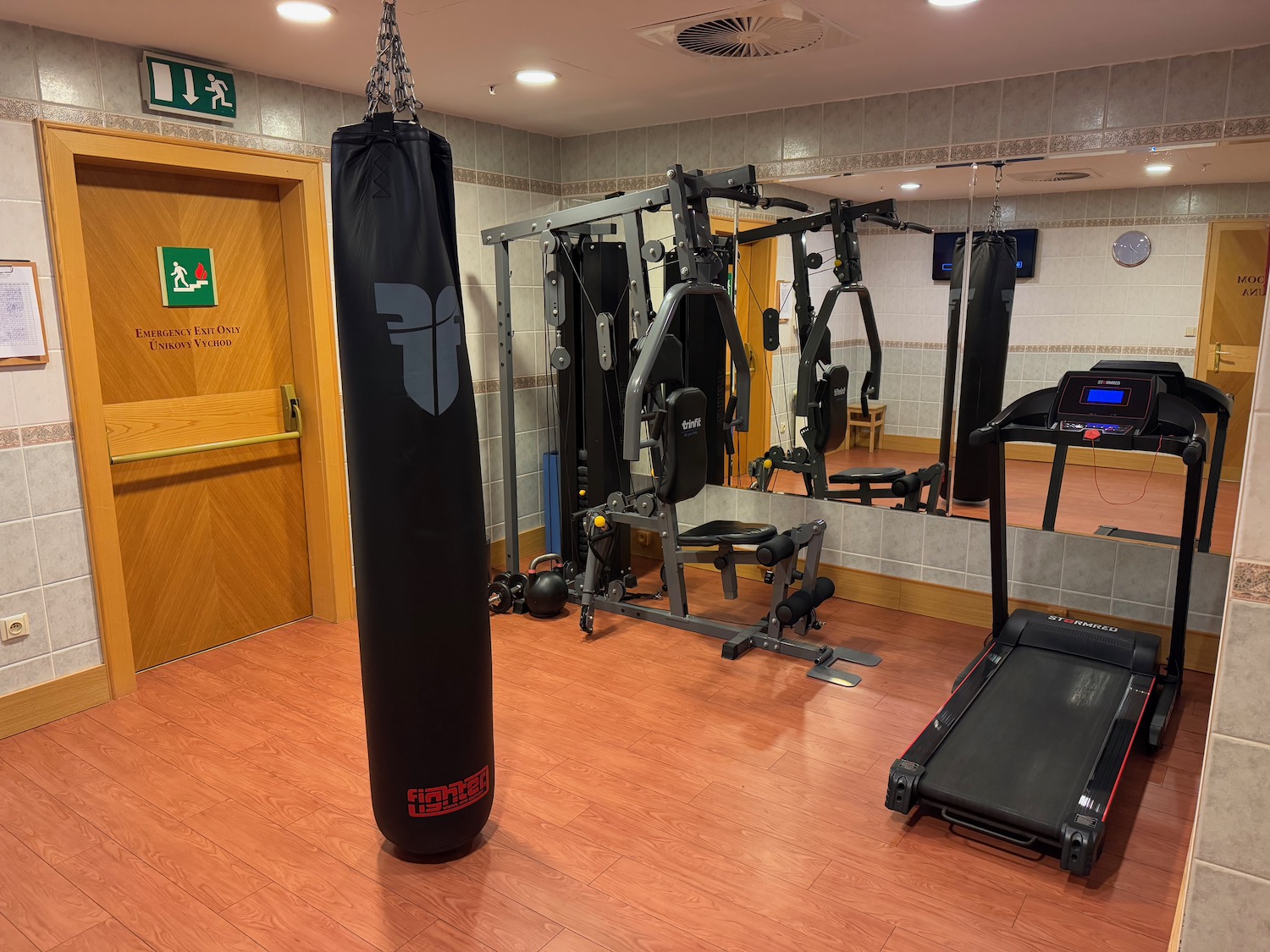 a gym with a punching bag and treadmills