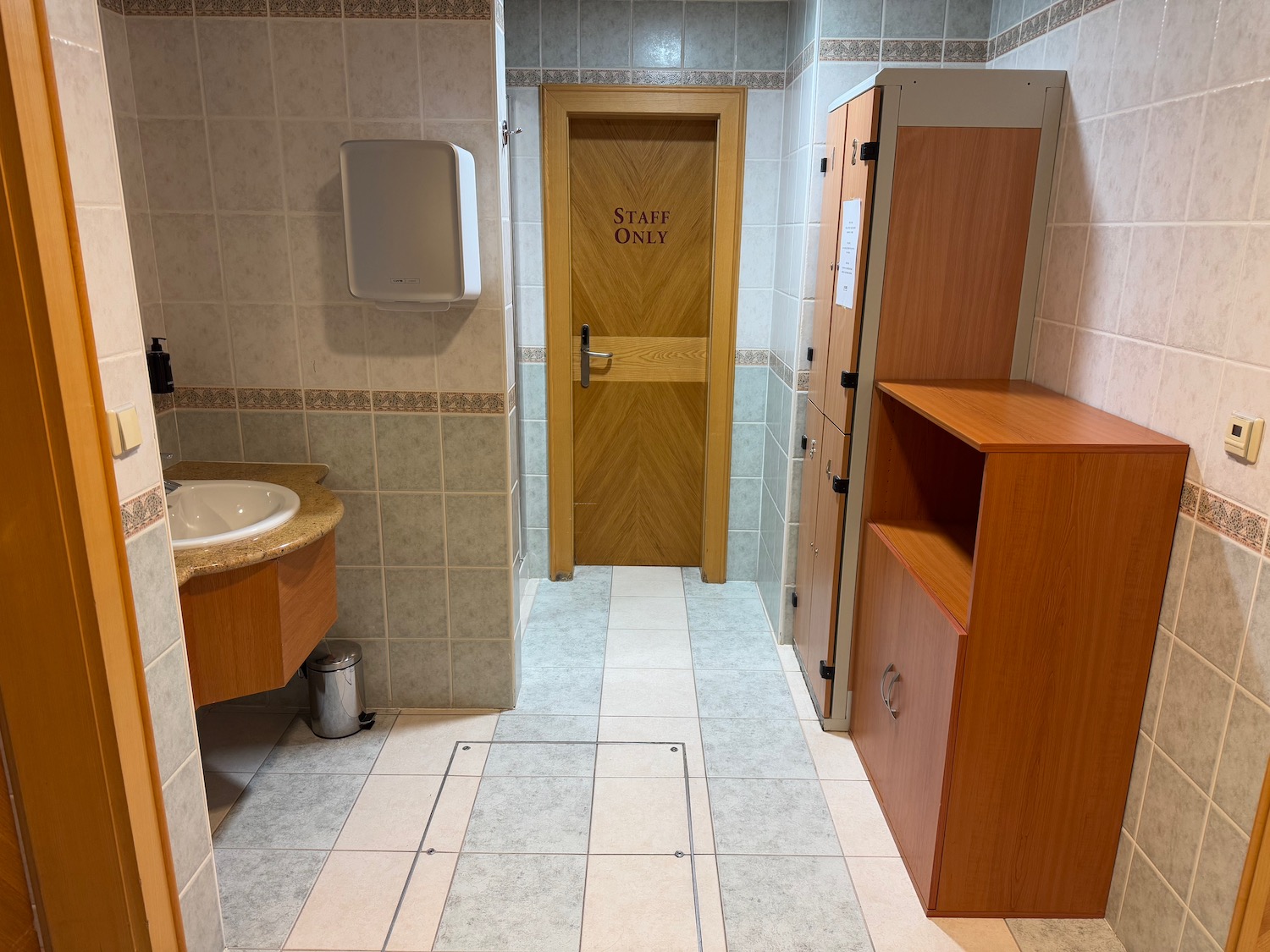 a bathroom with a door and sink