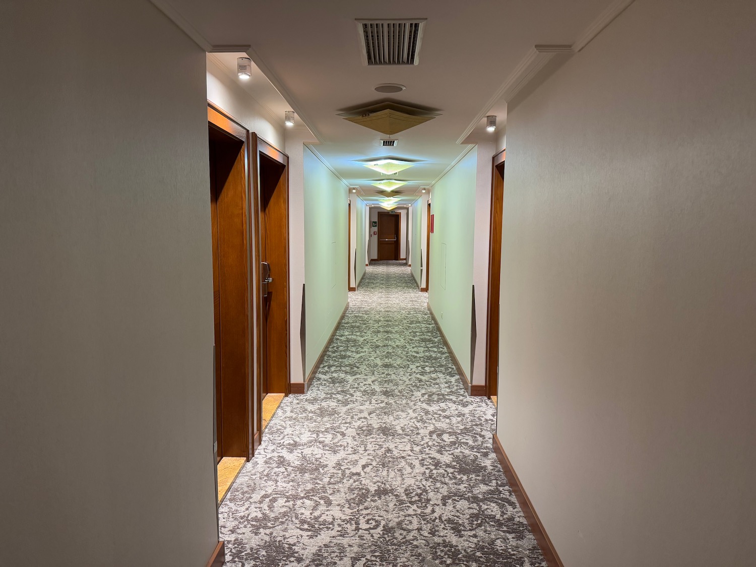 a hallway with doors and carpet