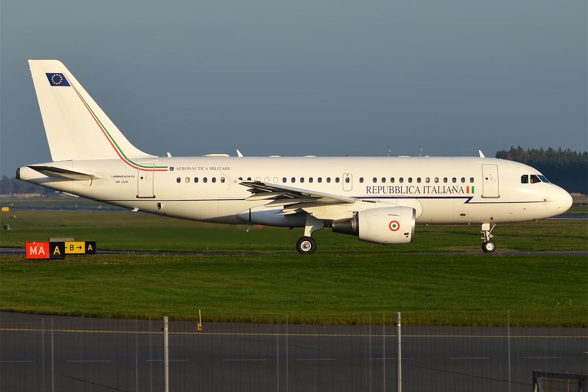 a white airplane on a runway