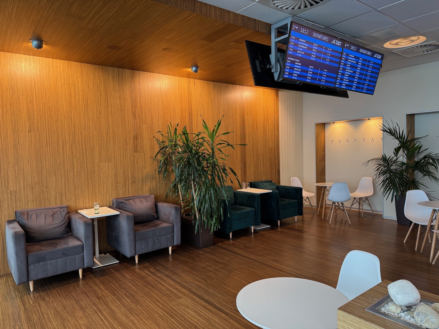 a room with chairs and tables and a screen