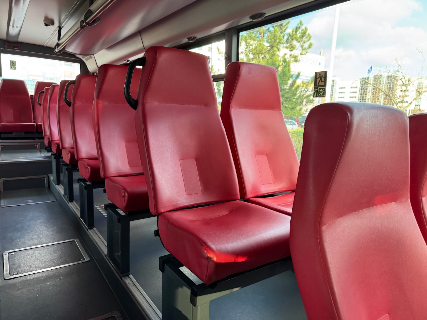 a row of red seats on a bus