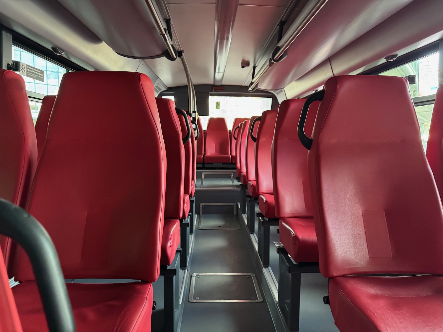 a row of red seats in a bus