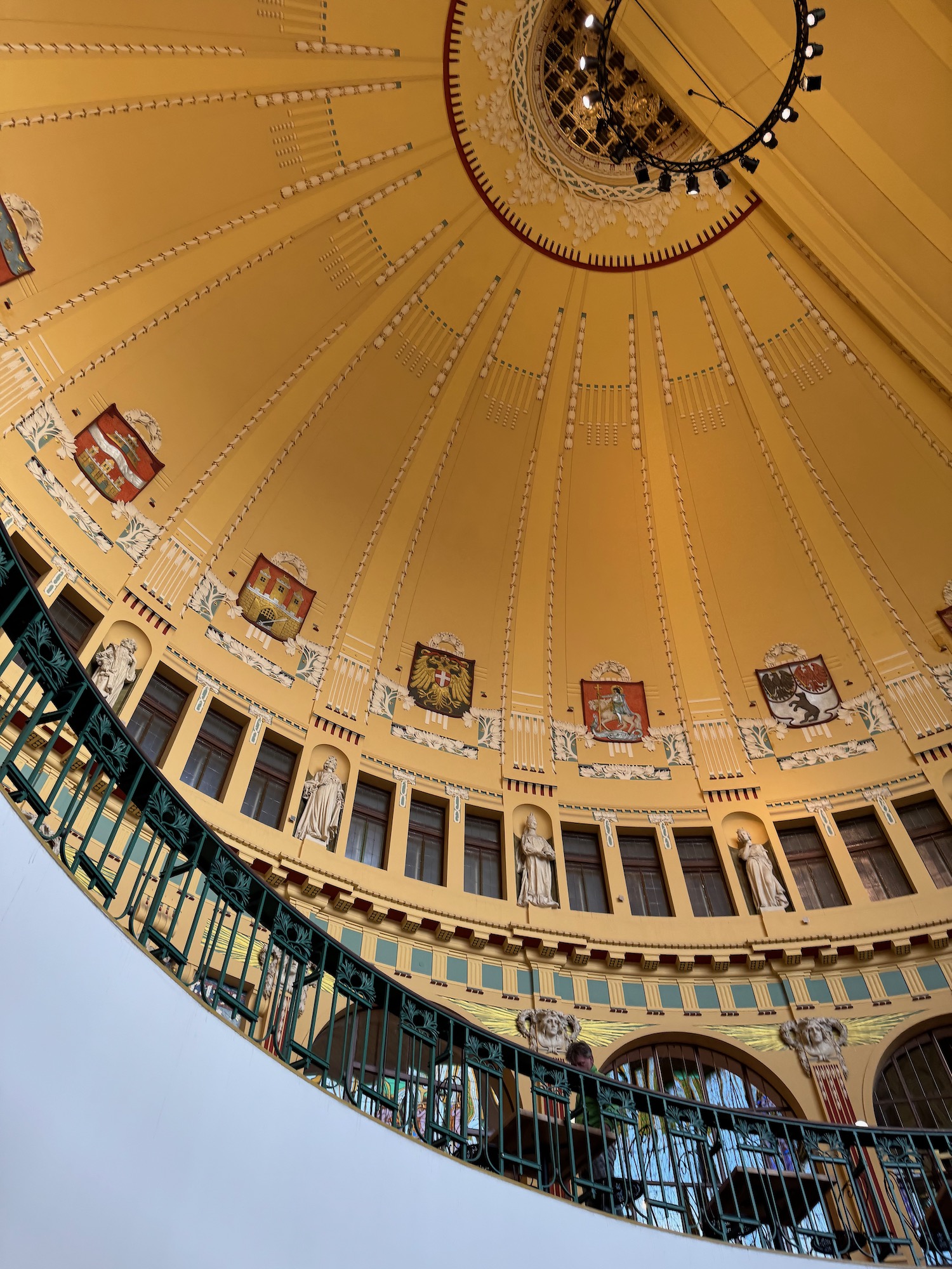 a circular building with a green railing