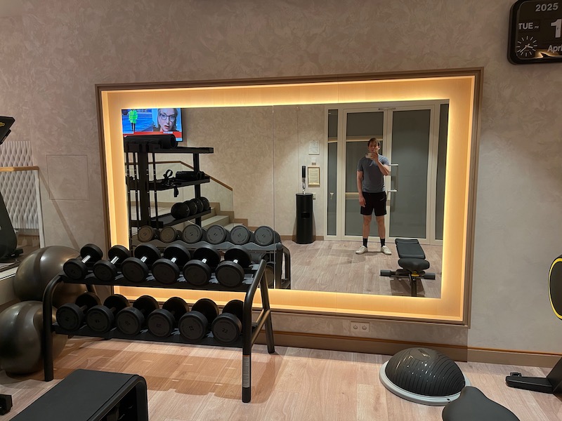 a mirror with a mirror and a man standing in front of a mirror