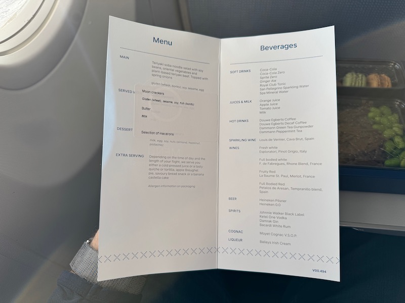a hand holding a menu