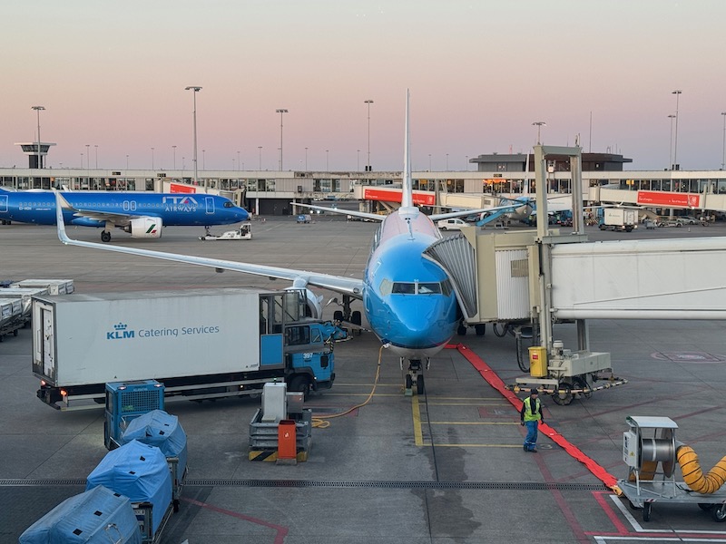 a blue airplane at an airport