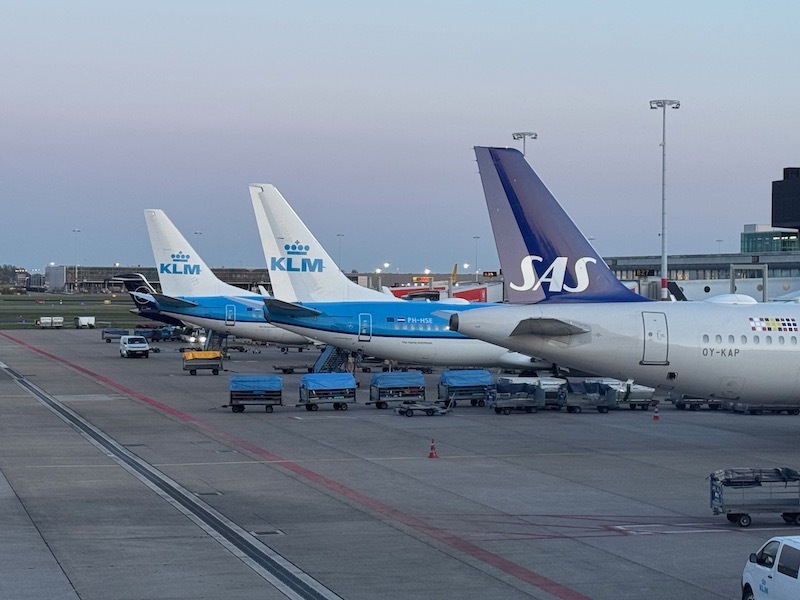 a group of airplanes parked at an airport