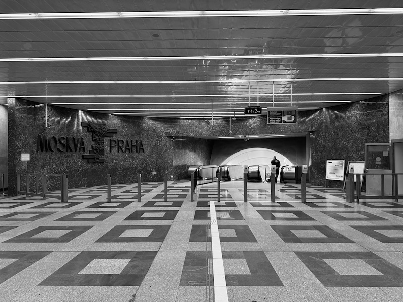 a black and white photo of a subway station