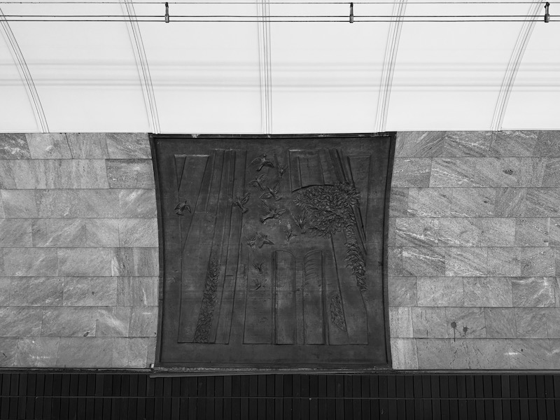 a black and white photo of a wall with a rectangular object