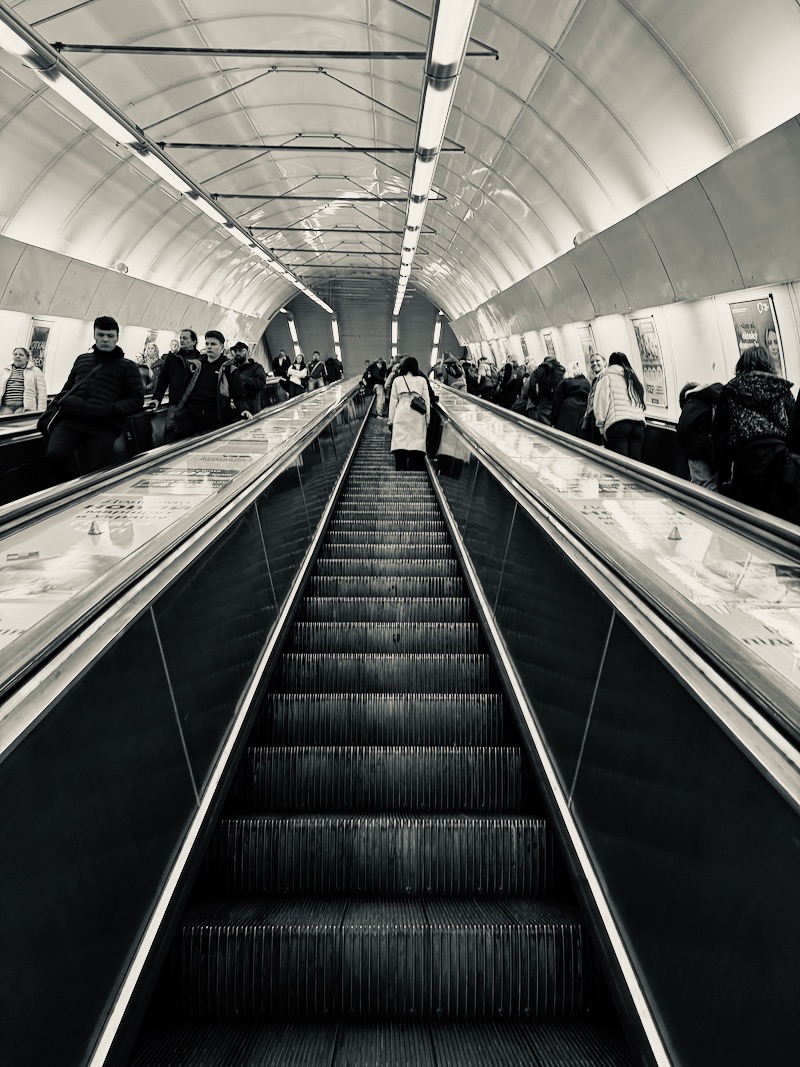 a group of people on an escalator