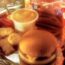 a hamburger and cookies on a tray