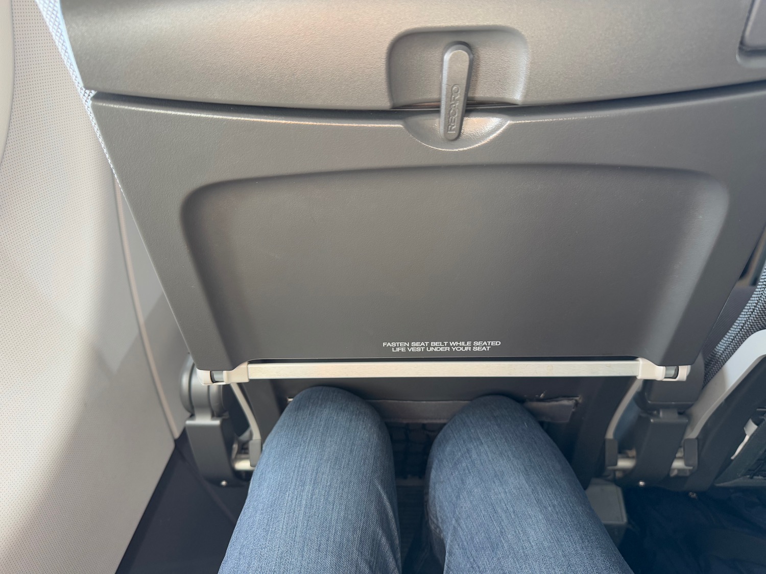 a person's legs in a seat