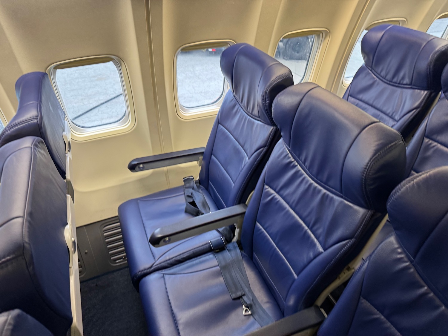 a row of blue seats on an airplane