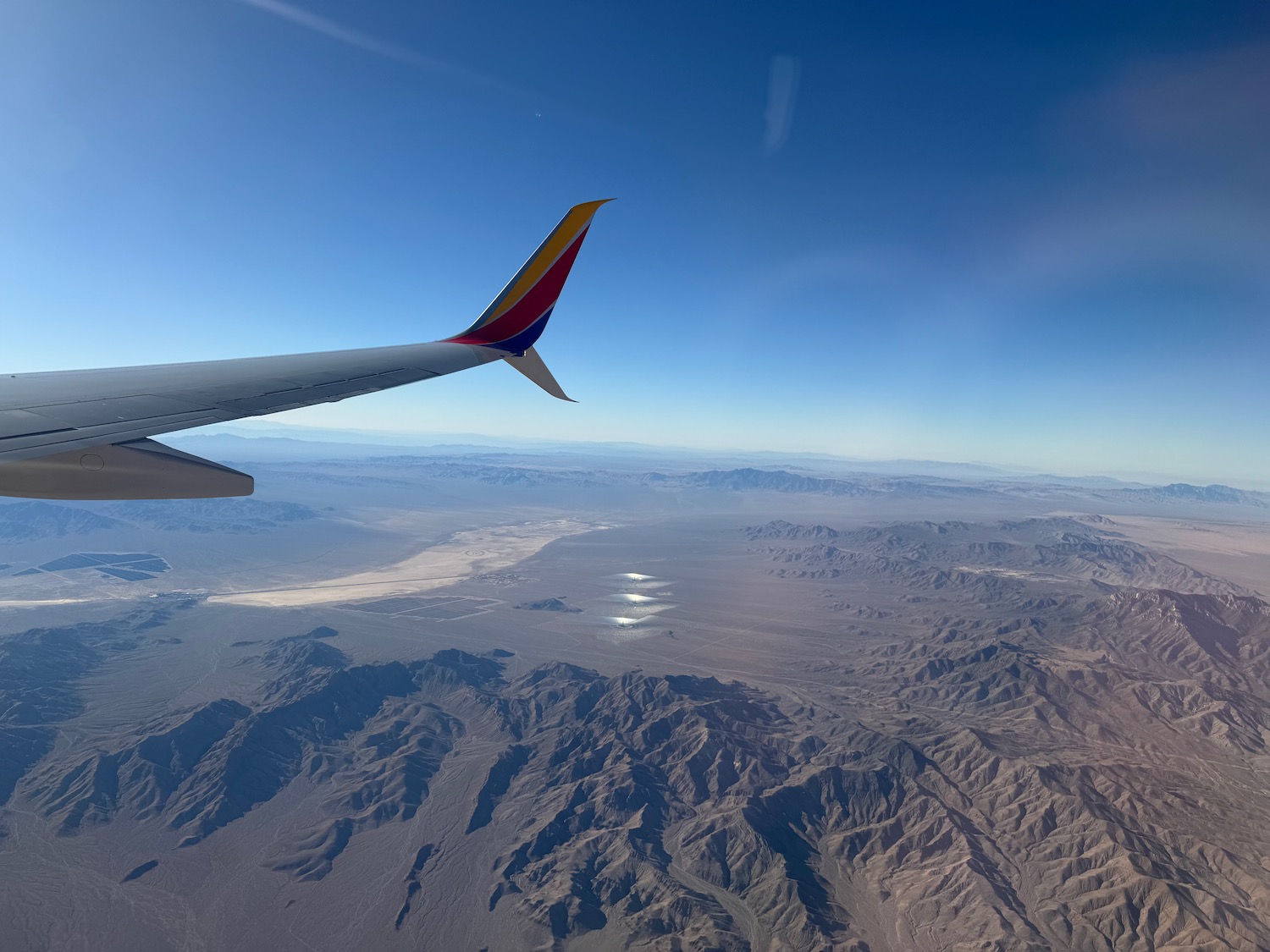 an airplane wing and mountains