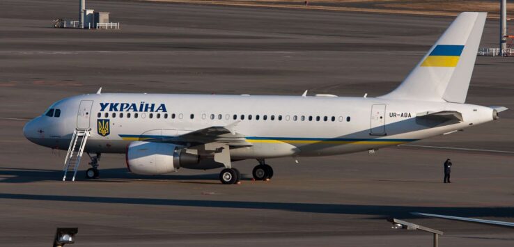 a white airplane on a runway