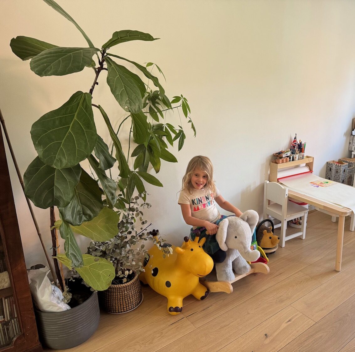 a girl riding a toy elephant