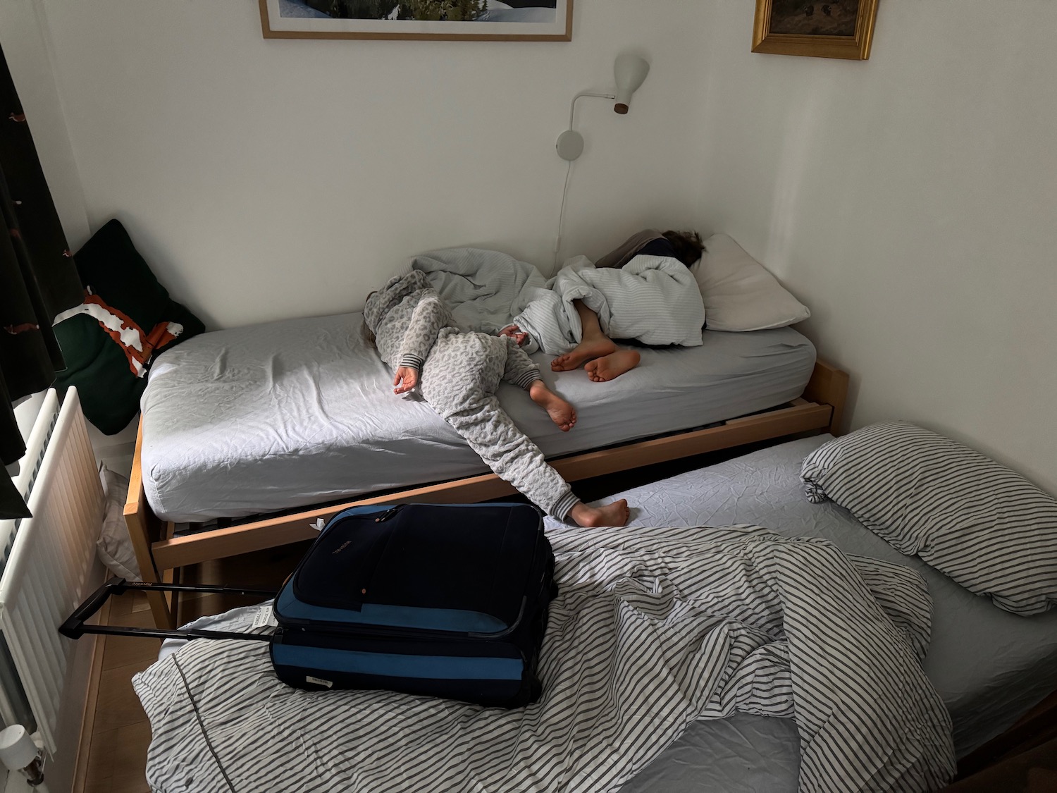 two people sleeping on a bed