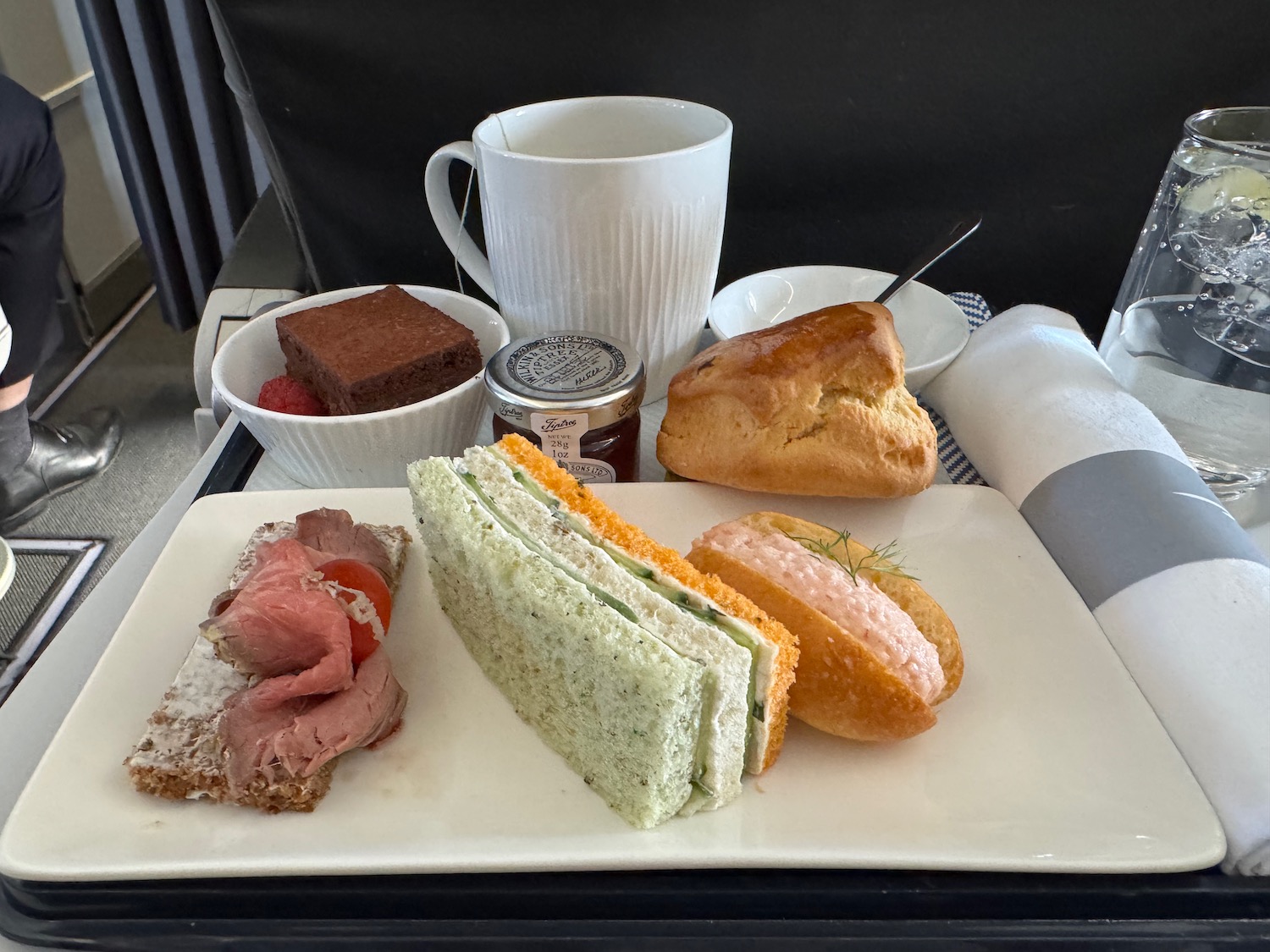 a plate of sandwiches and bread on a table