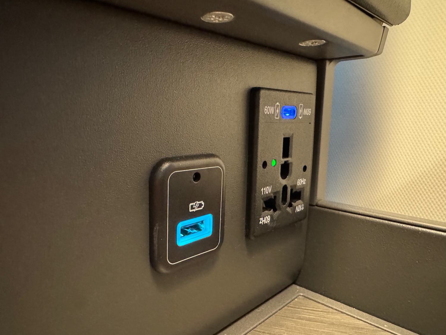 a black wall with a usb port and a black outlet