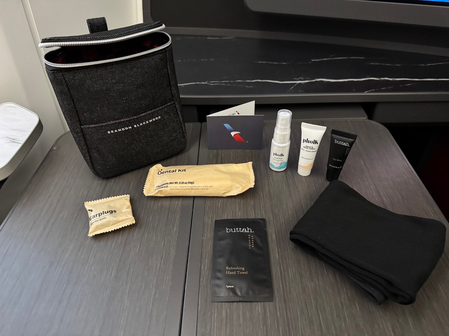 a small black bag with small items on a table